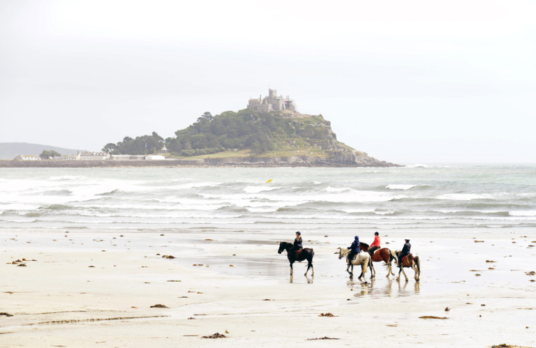 Horses on the beach in Mounts bay Cornwall