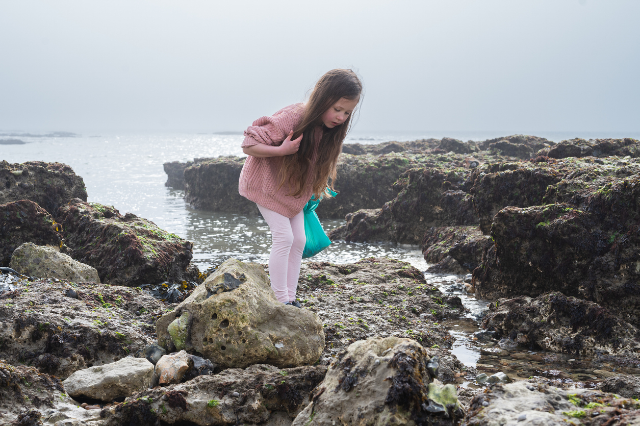 Little girl rock pooling