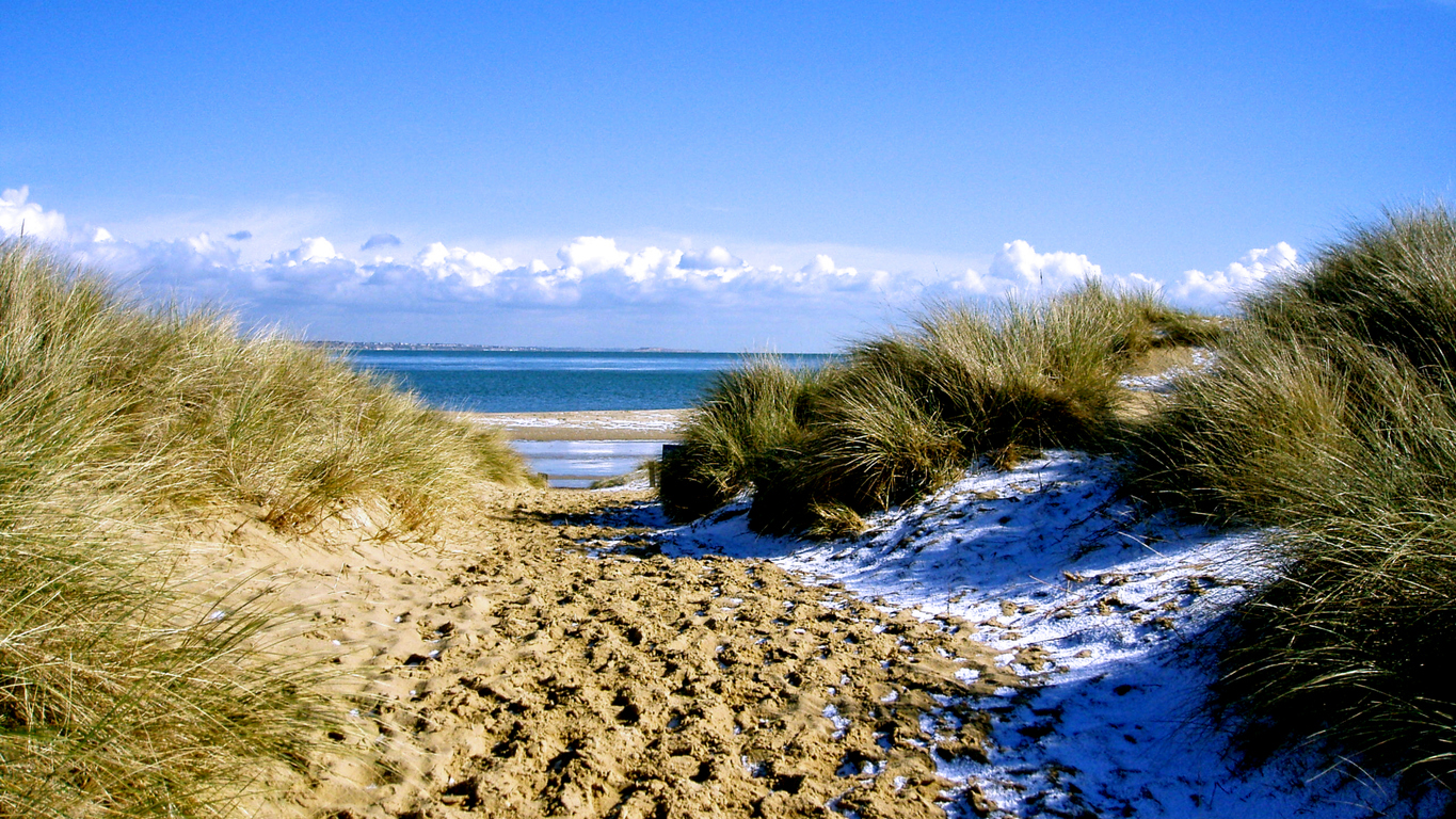 Huge storm clouds over snow covered beach