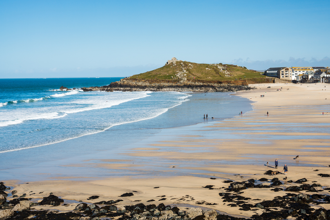 Overlooking the golden sandy Porthmeor Beach St Ives Cornwall England with The Island headland in the distance.