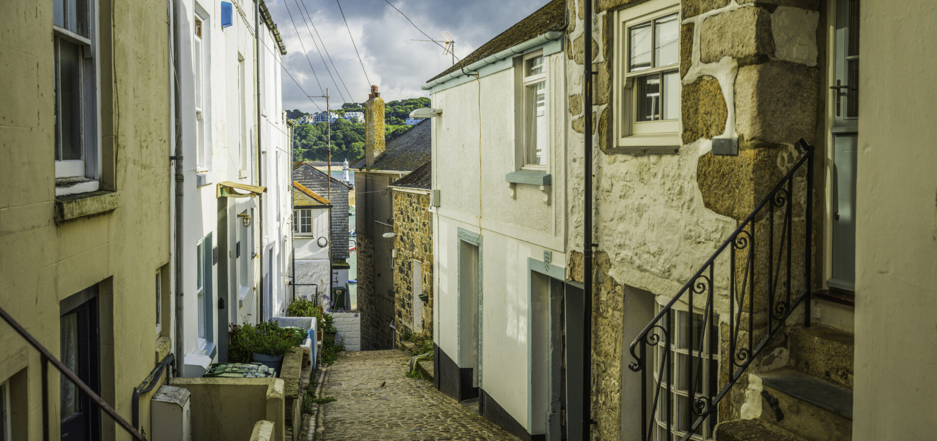 Quaint fisherman cottages on narrow cobbled alley St Ives Cornwall